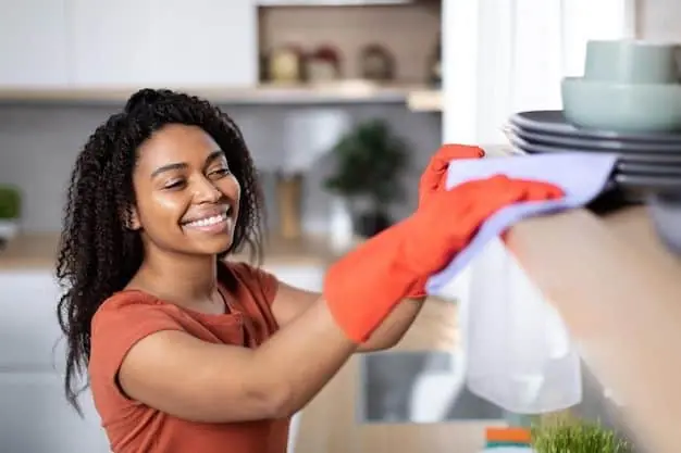 African Hourly maid cleaning a kitchen in Riyadh.